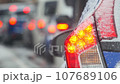 Winter, traffic jams, snow falling on car taillights 107689106