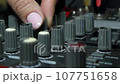 DJ Trendy girl plays music at night club party. Sound Designer Used Digital Audio Mixer In Production Studio. Spot light of multi-color neon. Funky dj mixing dance rhythm on mixer board. 107751658