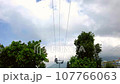 Ropeway cabin on the background of palms and clouds 107766063