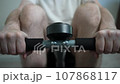 Home Fitness Routine Man Working Out With Rowing Machine 107868117