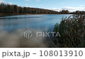 Reflection of blue clouds in a clear forest lake in autumn in October 108013910