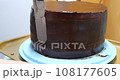 Confectioner woman is smearing cream on sides of cake using spatula, closeup view. culinary, baking and cooking food concept, home cooking 108177605