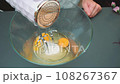 Beating a mixer raw eggs and sugar with a mixer 108267367