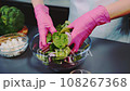 Mixing tasty vegetable salad with hands 108267368