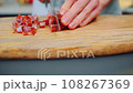 Slicing smoked sausages on a cutting board 108267369