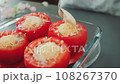 Adding Mayonnaise to Cheese Stuffed Tomatoes 108267370