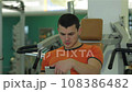 Young man looks through a training program 108386482
