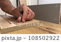 Assembling furniture with men's hands 108502922
