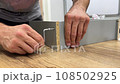 Assembling furniture with men's hands 108502925