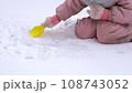 5 years old girl enjoying winter day on a fenced sports ground. Fun winter holidays. Playing with snow in a beautiful snowfall. Holiday outdoors in cold winter 108743052