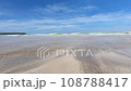 Watch the waves crashing on the sandy beach from a low position 108788417