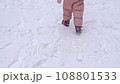 Close up video of 5 years old girl walking on a fenced sports ground. Fun winter holidays, enjoying winter day. Playing with snow in a beautiful snowfall. Holiday outdoors in cold winter 108801533
