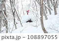 Jumping on a backcountry snowboard 108897055