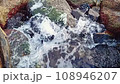 Water flowing through rocks 108946207