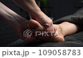 Professional foot massage. Authentic footage of luxury spa treatment. Charming light. Shallow depth of field. Stylized and colored. 109058783