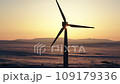 Wind turbines at sunrise in heavy fog. Wind farm generating green energy 109179336