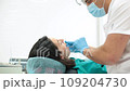Cute young girl is being examined by the dentist 109204730