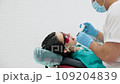 Cute young girl is being examined by the dentist 109204839