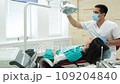 Cute young girl is being examined by the dentist 109204840