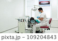 Cute young girl is being examined by the dentist 109204843