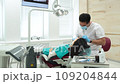 Cute young girl is being examined by the dentist 109204844