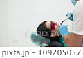 Cute young girl is being examined by the dentist 109205057