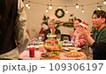 Happy asian people celebrating on a table meal when christmas and new year at home. 109306197