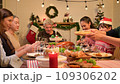 Happy asian people celebrating on a table meal when christmas and new year at home. 109306202