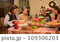 Happy asian people celebrating on a table meal when christmas and new year at home. 109306203