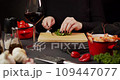woman's hands chop parsley for dinner 109447077