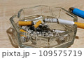 A cigarette smoldering in an ashtray. Timelapse. Cigarette butts in the ashtray 109575719