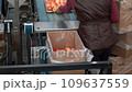 Female Packing House Worker Packing Fresh, Sorted and Waxed Apples into Environmentally Friendly Packaging. Apples in Consumer Units on Conveyor Belt in Packing House Prior Distribution to Market.	 109637559