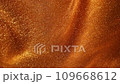 Atmospheric chaotic movement of gold particles in liquid. Impressive spectacle of shimmering shiny particles in fluid motion. Abstract flaming moving background in 4K resolution.  109668612
