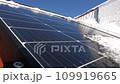 Snow Melting on PV Solar Panels Located on Private House Roof on Sunny Day 109919665