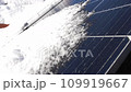 Snow Melting on PV Solar Panels Located on Private House Roof on Sunny Day 109919667