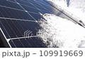 Snow Melting on PV Solar Panels Located on Private House Roof on Sunny Day 109919669