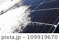 Snow Melting on PV Solar Panels Located on Private House Roof on Sunny Day 109919670