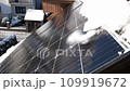 Snow Melting on PV Solar Panels Located on Private House Roof on Sunny Day 109919672