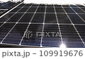 Snow Melting on PV Solar Panels Located on Private House Roof on Sunny Day 109919676