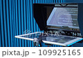 teleprompter for video. The reading text is reflected from the glass surface opposite the video camera lens 109925165