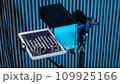 teleprompter for video. The reading text is reflected from the glass surface opposite the video camera lens 109925166