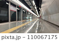 blurred background with interior of a metro or subway station with arriving train and passengers. 110067175