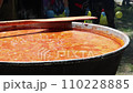 Tomato soup with pasta is a dish of Polish cuisine. Hot Zupa pomidorowa in a large cauldron at the field kitchen at a food fair. A popular soup made from grated tomatoes in their own juice 110228885
