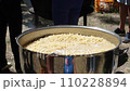 Tomato soup with pasta is a dish of Polish cuisine. Hot Zupa pomidorowa in a large cauldron at the field kitchen at a food fair. A popular soup made from grated tomatoes in their own juice 110228894