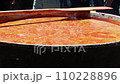 Tomato soup with pasta is a dish of Polish cuisine. Hot Zupa pomidorowa in a large cauldron at the field kitchen at a food fair. A popular soup made from grated tomatoes in their own juice 110228896