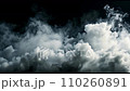White smoke rising above a black background. 110260891