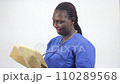 portrait of young woman with envelope, smiling. portrait of young woman with envelope, smiling. 110289568