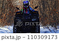 The ATV rides in slow motion through the snow 110309173