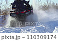 The ATV rides in slow motion through the snow 110309174