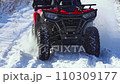The ATV rides in slow motion through the snow 110309177